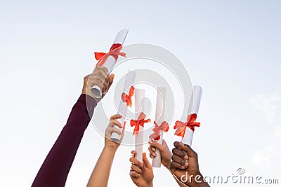 Students graduation, hands and certificate in sky for success, education and future. Closeup group, graduates and Stock Photo