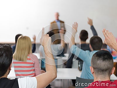 Students group raise hands up on class Stock Photo