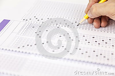 Students hand doing exams quiz test paper at school Stock Photo