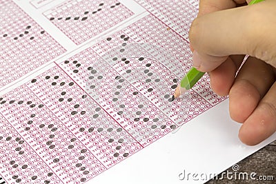 Students hand doing exams quiz test paper Stock Photo