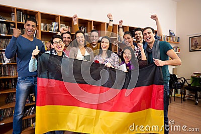 Students with hands raised and smiling faces present German country Stock Photo