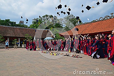 Students having graduation ceremony in Temple of Literature with hats up in the air Editorial Stock Photo