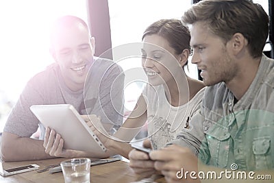 Students in a lounge campus connected to internet Stock Photo