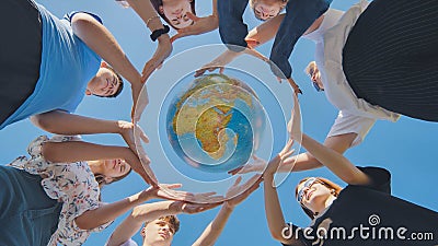 Students make a circle around the globe of the world. The concept of world peace. Stock Photo