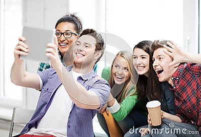 Students making picture with tablet pc at school Stock Photo