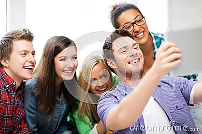 Students making picture with tablet pc at school Stock Photo