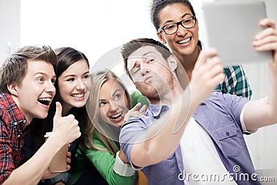 Students making picture with tablet pc at school Stock Photo