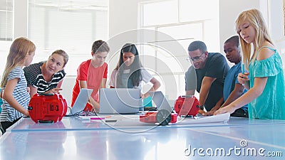 Students With Male And Female Teachers In School Computer Coding Class Programming Robot Vehicle Stock Photo