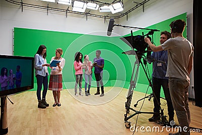 Students On Media Studies Course In TV Studio Stock Photo