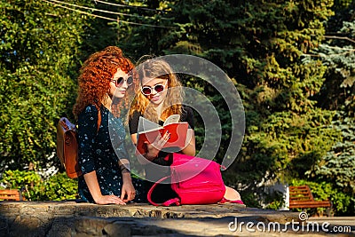 Students read a book in park. Stock Photo