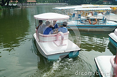 The students are ready to play with the small boat. Editorial Stock Photo