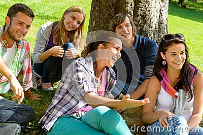 Students relaxing in schoolyard teens meadow park Stock Photo