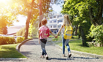 Students With Rucksacks Walking In The Park Stock Photo