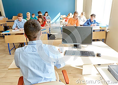 Students and teacher with pc computer at school Stock Photo