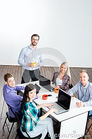 Students with teacher studying using modern technologies Stock Photo