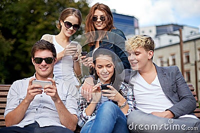 Students or teenagers with smartphones at campus Stock Photo