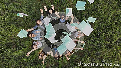 Students toss exercise books on their last day of school. Stock Photo