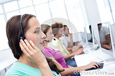 Students using headsets in computer class Stock Photo