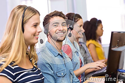 Students using headsets in computer class Stock Photo
