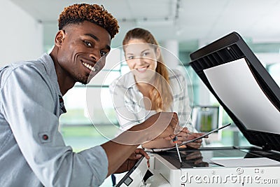 students using xerox photocopier in library at school Stock Photo