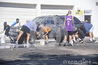 Students washing cars for a school fundraiser, NM Editorial Stock Photo