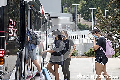 Students wear protective face masks while boarding a bus on the University of Georgia campus Editorial Stock Photo