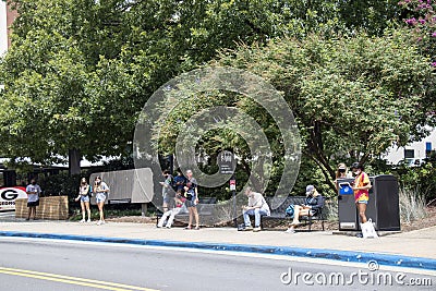 Students wear protective face masks while waiting for a bus on the University of Georgia campus Editorial Stock Photo