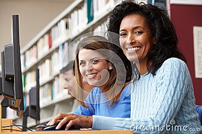 Students working on computers in library Stock Photo