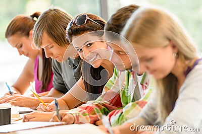 Students writing at high-school exam teens study Stock Photo