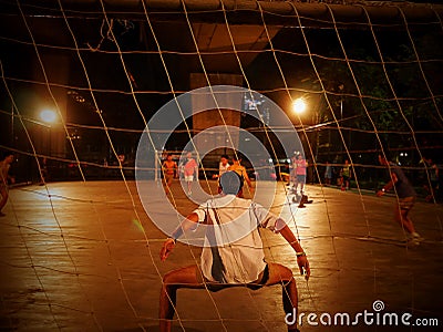 Students and young adults play soccer at night in Bangkok, Editorial Stock Photo