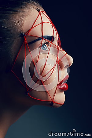 Studio beauty portrait of youg woman with red web Stock Photo