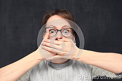 Portrait of girl covering mouth with hands Stock Photo