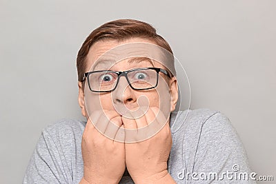 Portrait of shocked frightened man panicking and biting nails Stock Photo