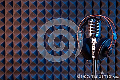 Studio condenser microphone with professional headphones acoustic panel Editorial Stock Photo