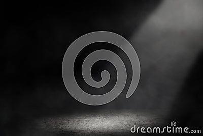 Studio dark room with spot lighting and fog in black background. Stock Photo