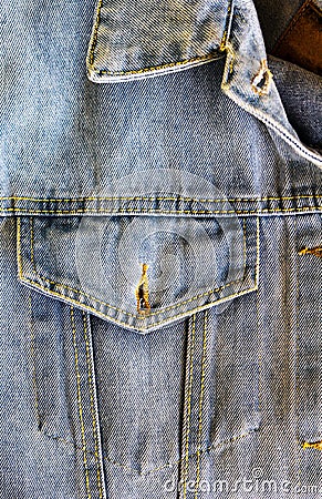 Studio denim open chest pocket and collar corner of blue denim jacket close-up, clothes, jeans, buttonhole, fabric texture Stock Photo