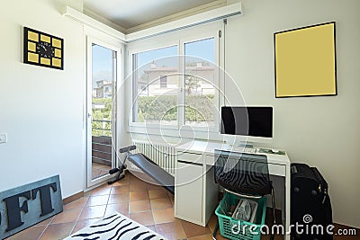 Studio with desk, computer, windows and balcony Stock Photo