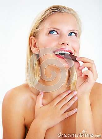 Studio happiness, woman thinking and eating chocolate, delicious snack or look at sugar product, candy or dessert Stock Photo