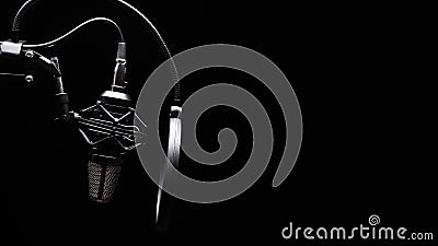 Studio microphone with pop filter with dramatic light. Concept. Leading radio, bloggers, singers, track recording, voice acting. Stock Photo