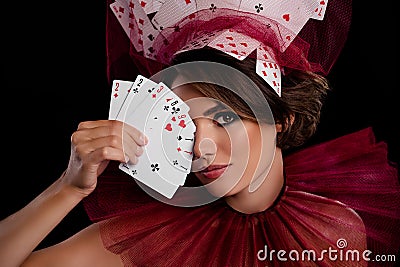 Studio photo stunning woman dealer hold cards near face close eye wear masquerade costume casino night game Stock Photo