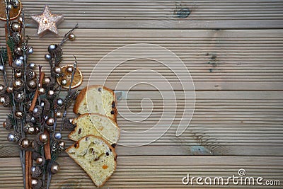 Christmas photography with silver and gold colored acorn tree ornament on natural rustic wood background with panettone cake bread Stock Photo