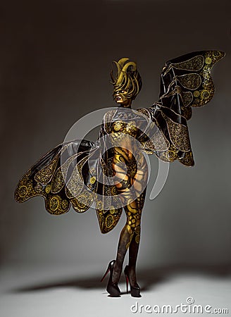 Studio portrait of beautiful model with fantasy golden butterfly body art Stock Photo