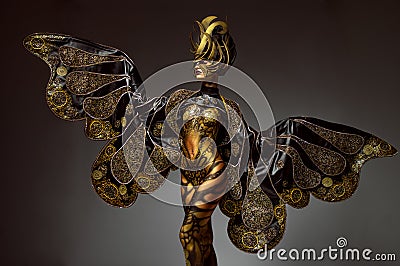 Studio portrait of beautiful model with fantasy golden butterfly body art Stock Photo