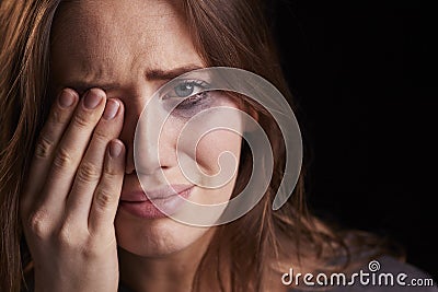 Studio Portrait Of Crying Young Woman With Smudged Eye Make Up Stock Photo