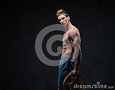 Ectomorph shirtless athletic male holds barbell weight. Stock Photo