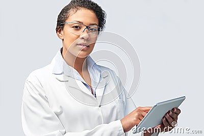 Studio Portrait Of Female Laboratory Technician Working With Digital Tablet Stock Photo