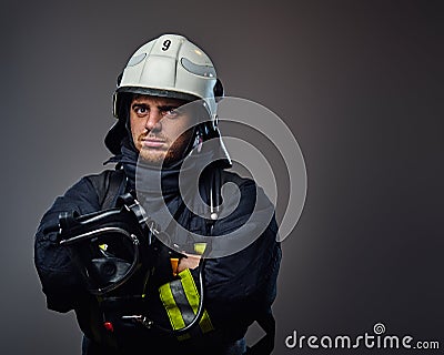 Studio portrait of firefighter dressed in uniform. Stock Photo