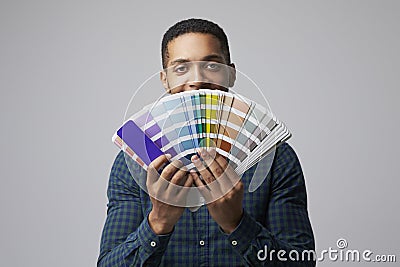 Studio Portrait Of Graphic Designer With Color Swatches Stock Photo