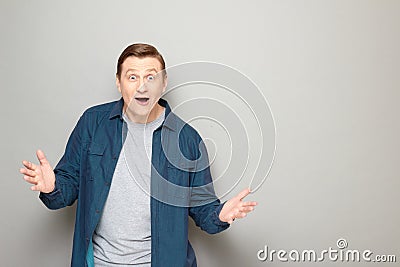 Portrait of happy astonished man raising hands and greeting somebody Stock Photo