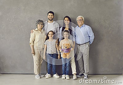 Studio portrait of happy multi generational family standing together and smiling Stock Photo